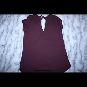 Burgundy T shirt with a v- neck style.